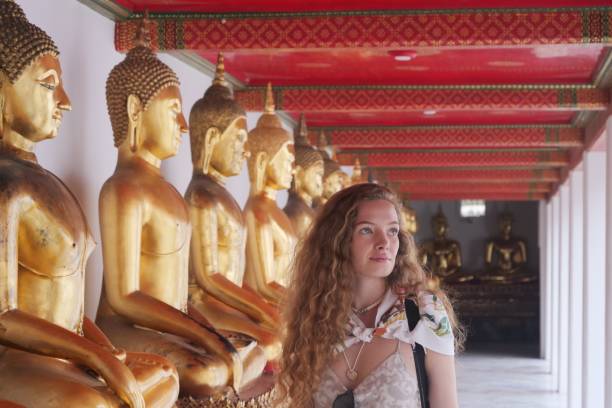 istock Young tourist woman visiting temple 927809630