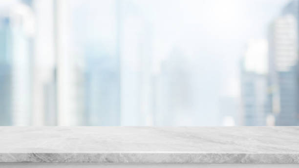 istock Empty white marble stone table top and blur glass window wall building with city view background - can used for display or montage your products. 927809984