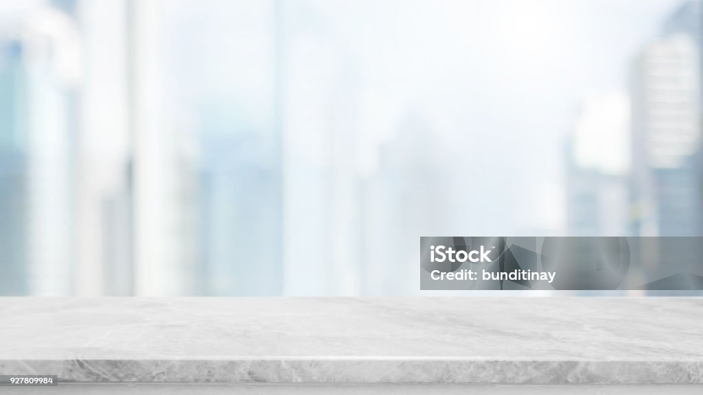 Empty white marble stone table top and blur glass window wall building with city view background - can used for display or montage your products. Table Stock Photo