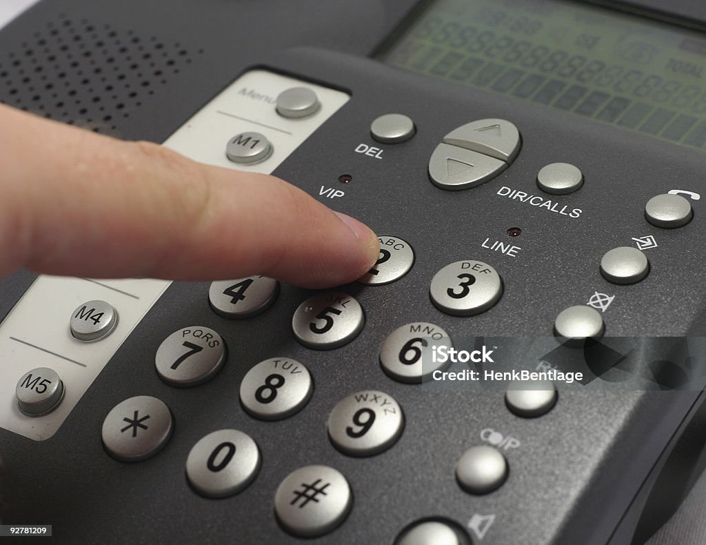 Dailing number on a telephone  Using Phone Stock Photo