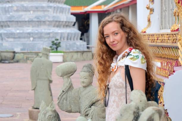 istock Young tourist woman at temple 927813064