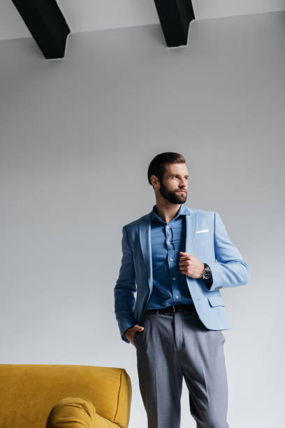 istock bearded stylish man posing in blue trendy suit 927817606
