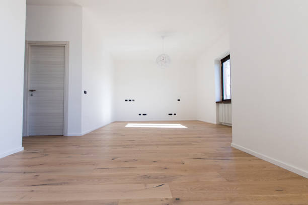 Empty sale apartment with white walls and natural wood oak parquet. Renovated flat without furniture with white light. stock photo