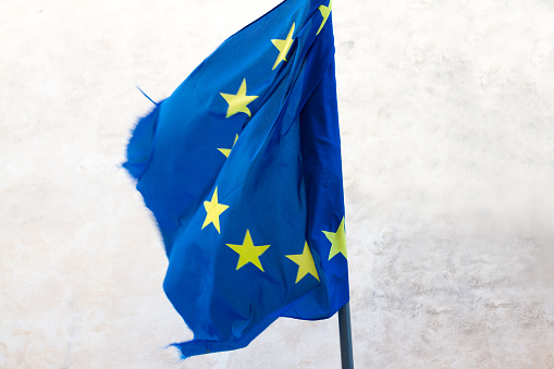 Tattered Old EU Flag Flying; White Background