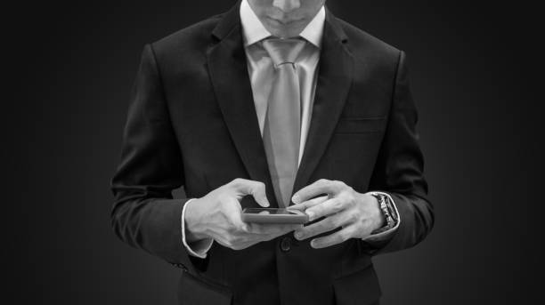 istock Businessman in dark blue suit using mobile smart phone, on blue background 927826226