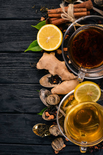istock Black and green tea with lemon, honey, cinnamon and ginger. Hot drink Top view. Copy space. 927826654