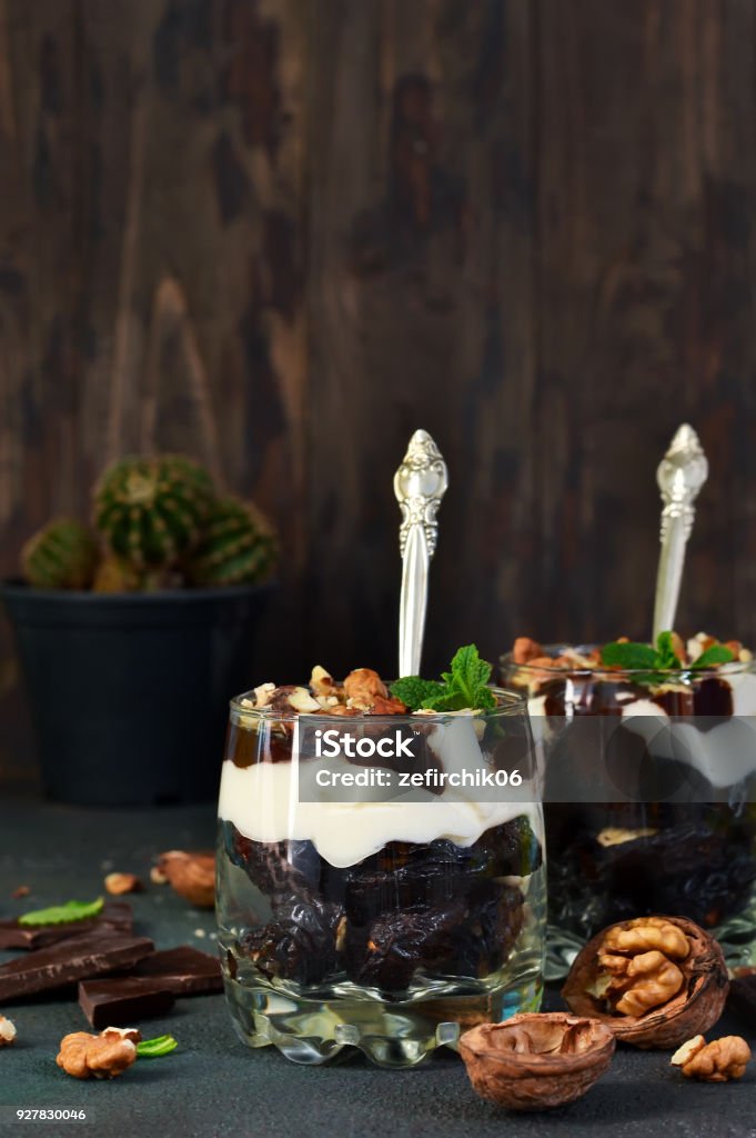 A homemade dessert with vanilla cream, cookies, prunes and nuts. Backgrounds Stock Photo