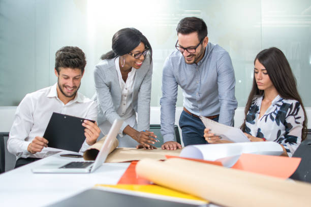 istock Team of architects working on construction plans in the office. 927839174