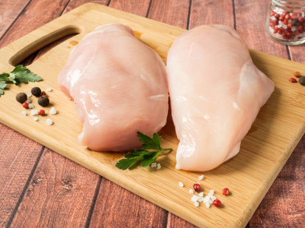 fresh chicken meat on wooden board on table. selective focus, horizontal. - pink pepper fotos imagens e fotografias de stock