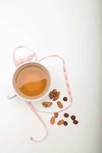 istock Cup of tea with assorted dried nuts and tape 927840040
