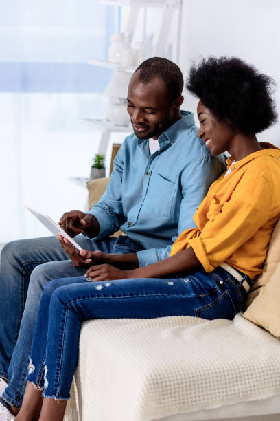 istock african american couple watching something on tablet at home 927840108