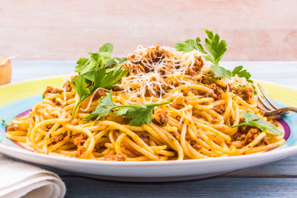 istock Spaghetti bolognese with cheese close-up on a rustic light background 927843524