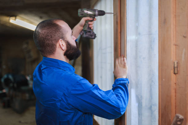 istock Young man repairing window indoors with an electric drill 927844056