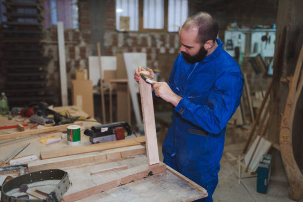 istock Carpenter making objects of wood in the workshop 927845458