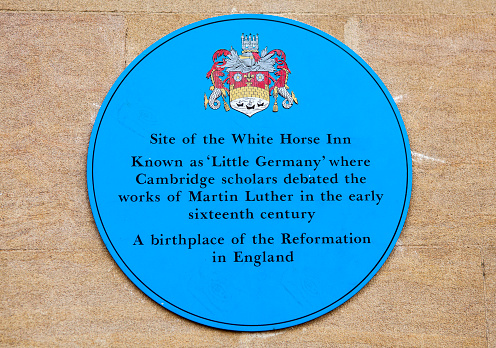 CAMBRIDGE, UK - OCTOBER 4TH 2015: A blue plaque marking the location of the White Horse Inn once stood where Cambridge scholars used to debate the works of Martin Luther in the sixteenth century, in Cambridge on 4th October 2015.