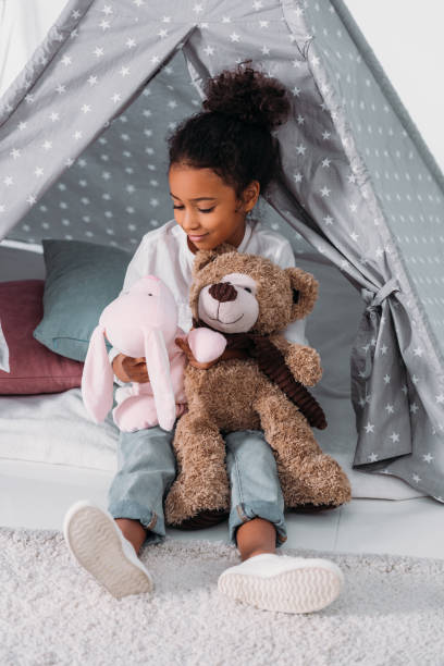 istock african american kid hugging soft toys 927845892