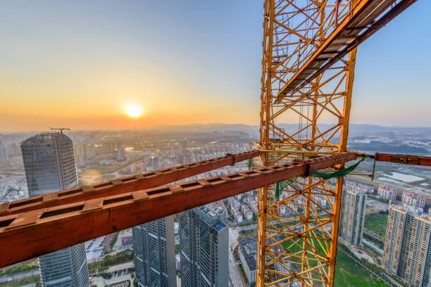 istock The construction site, steel structure and crane at the setting sun. 927846210