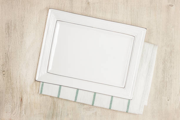 istock Empty plate  and towel napkin on wooden table 927847796