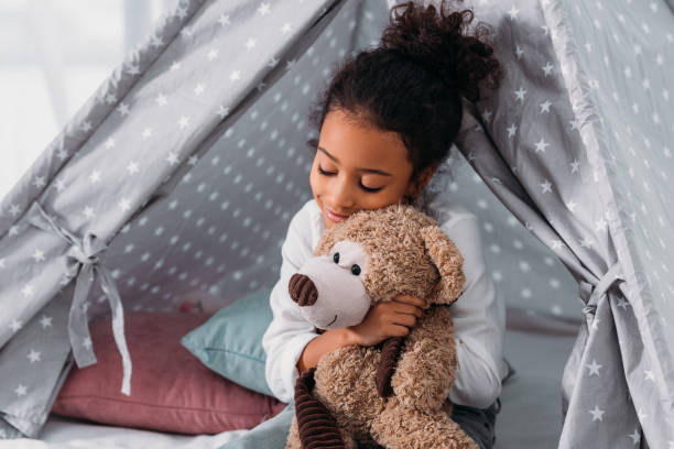 istock african american kid hugging teddy bear 927848446