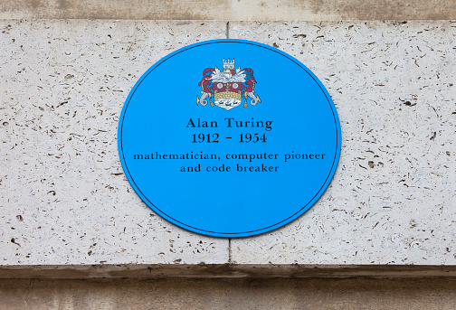 CAMBRIDGE, UK - APRIL 8TH 2016: A blue plaque at Kings College in Cambridge commemorating former student and computer pioneer Alan Turing, taken on 8th April 2016.