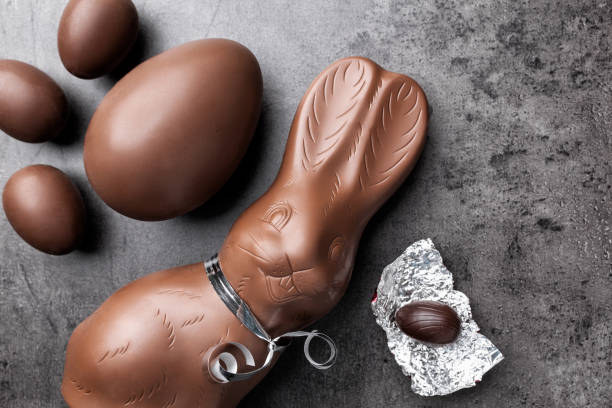Chocolate Easter bunny and eggs on rustic background Delicious chocolate Easter bunny and eggs on rustic background chocolate bunny stock pictures, royalty-free photos & images