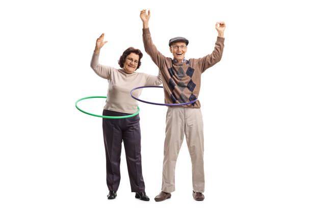 istock Two cheerful seniors with hula-hoops 927850178