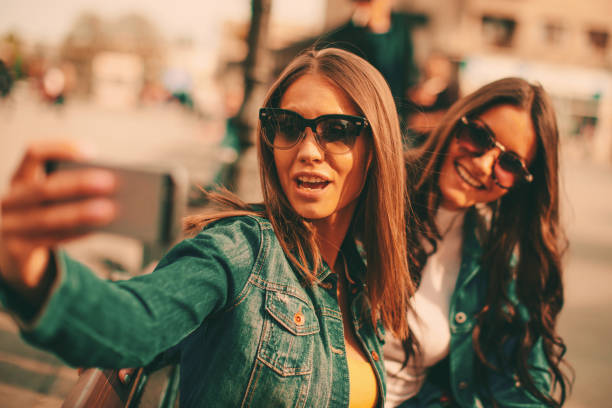 istock Two beautiful young woman taking selfie 927856372