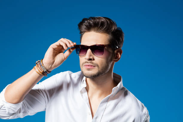 istock Summer portrait of handsome man, blue background 927856392