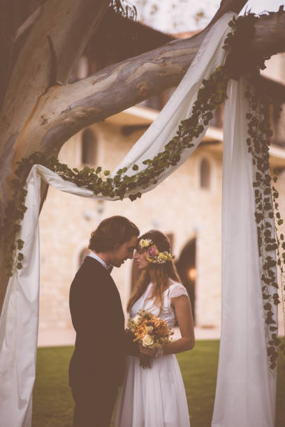 istock Newlywed husband and wife embracing during wedding ceremony 927860800