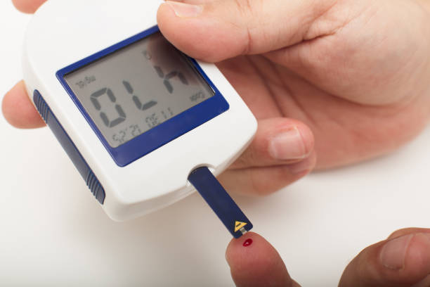 istock Man with diabetes using a portable glucose meter 927860828