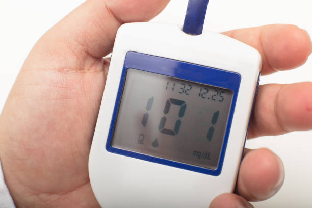 istock Man holding a portable digital glucose meter 927860840