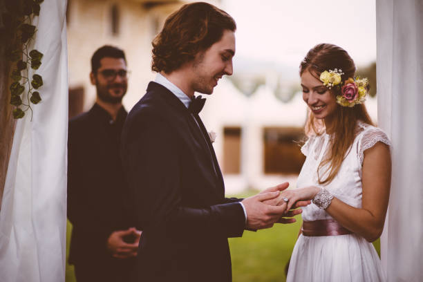 istock Bride and groom exchanging vows and wedding rings during ceremony 927863790