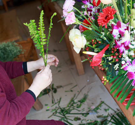 a woman is decorating flowers,Flower arranging scene