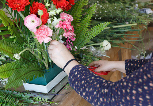 a woman is decorating flowers,Flower arranging scene
