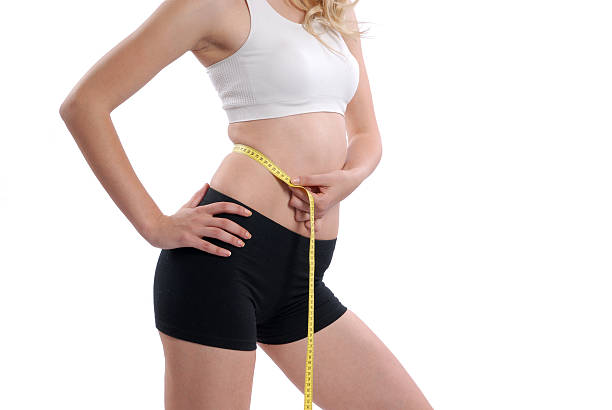 Slim woman measuring waist stock photo