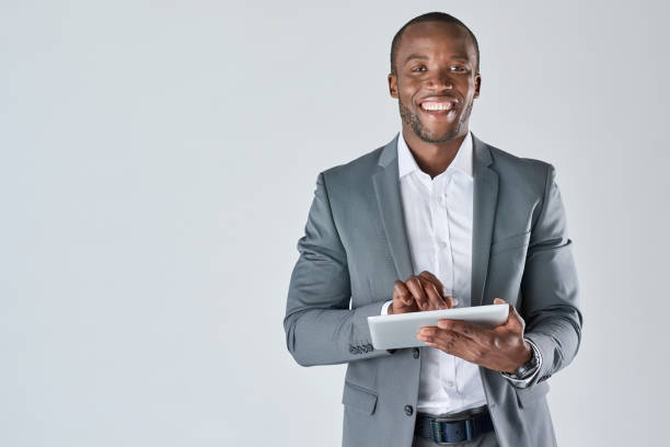 istock Smiling corporate professional on his tablet device 927868360