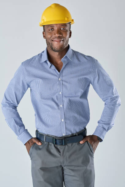 istock Studio portrait of black architect in yellow hardhat 927868518