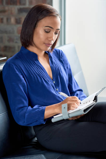istock Executive business woman writing in her organiser 927872164