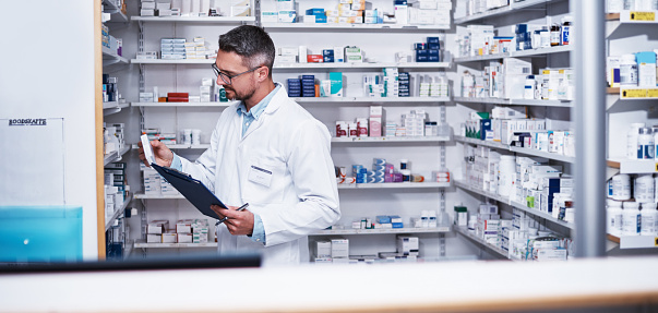 Shot of a mature pharmacist doing inventory in a pharmacy