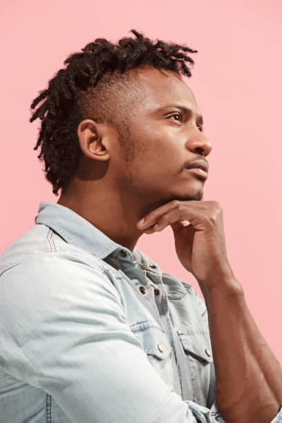 istock Young serious thoughtful Afro-American businessman. Doubt concept. Profile view 927876122