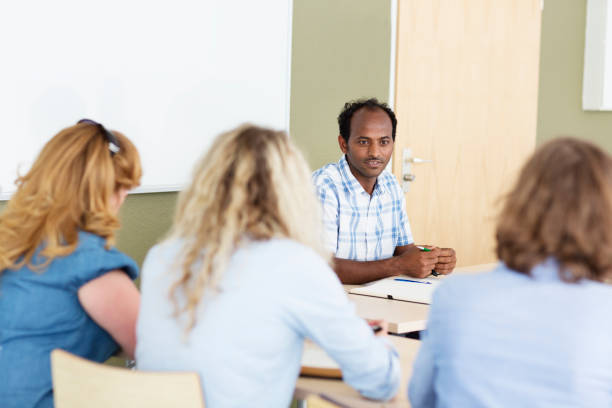 istock african teacher having discussion with students 927876740