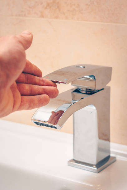 istock A drop hangs on the faucet in the bathroom, saving natural resources, saving water 927879392
