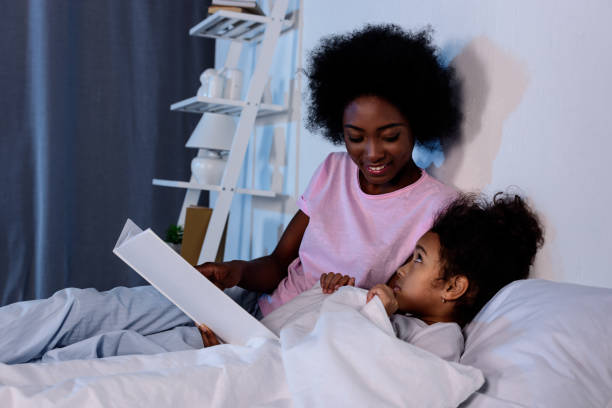 istock african american mother reading daughter in evening 927880940