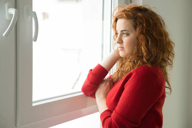istock Girl  by the window 927887702