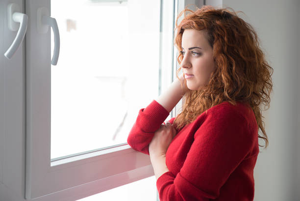 istock Girl  by the window 927887710