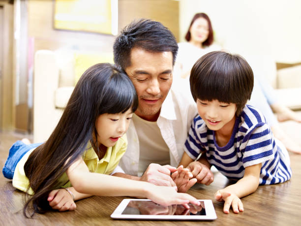 istock asian dad having fun with two children 927887754