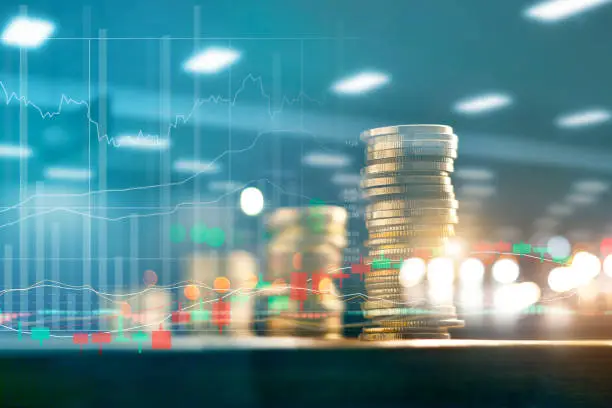 Photo of Finance and business investment concept. Graph and rows with statistic growth of coins on table.