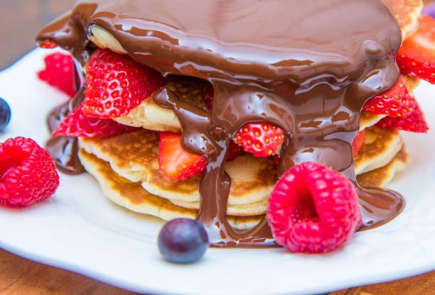 istock dish with pancakes and strawberry,raspberry and blueberry and chocolate 927888506