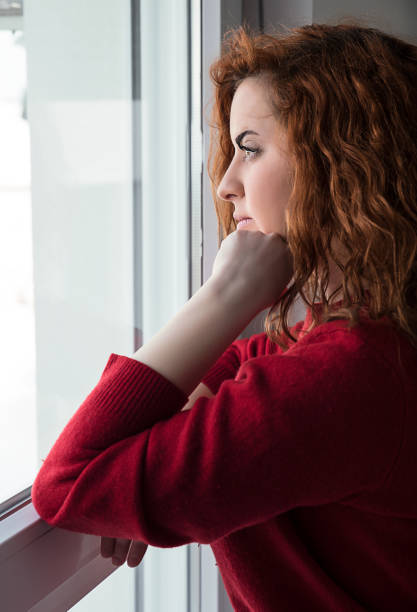 istock Girl  by the window 927888648