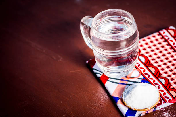 istock Water & salt,sodium chloride on wooden surface. 927889236